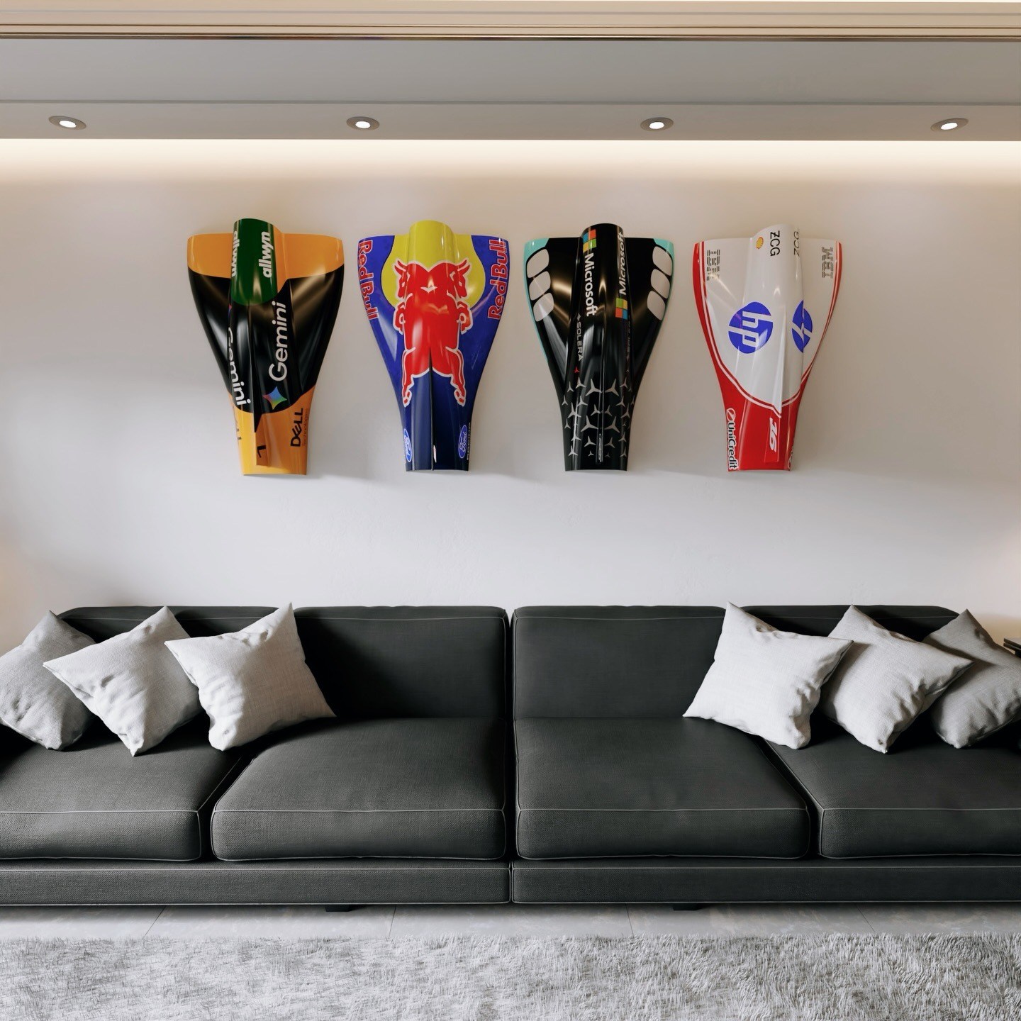 Four 3D-printed Formula 1 nose cones in team liveries mounted above a sofa.